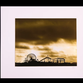 The Santa Monica Pier as seen in a new light. A sepia photograph printed with metallic ink, a unique, haunting image. 16" x 20" Matted.