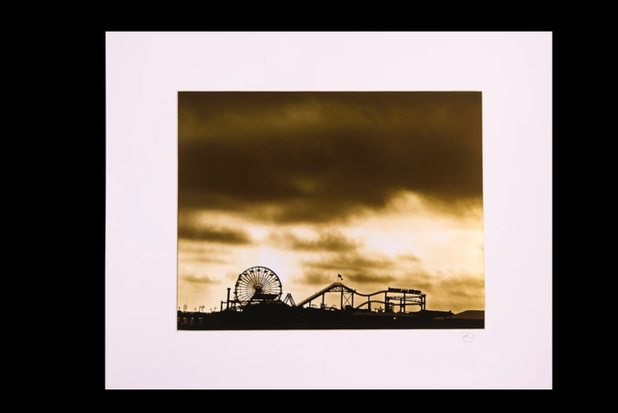 Screen Shot 2019-08-22 at 4.45.56 PM The Santa Monica Pier as seen in a new light. A sepia photograph printed with metallic ink, a unique, haunting image. 16" x 20" Matted.
