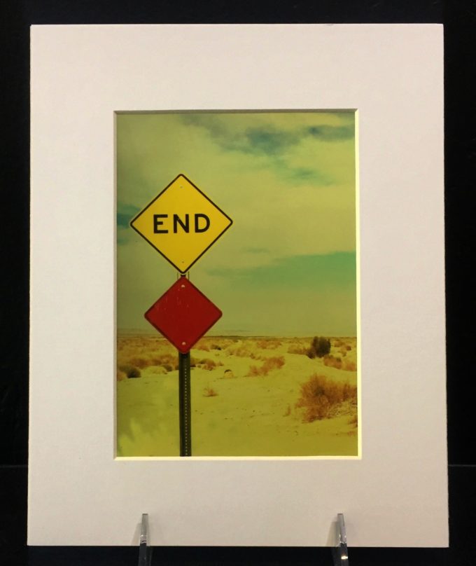 end End. Colorful photo printed with metallic ink, creating an almost 3-D effect. Photo taken in Salton Sea, CA.