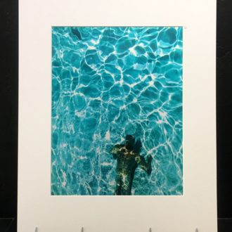 Weems in Pool. Colorful photo printed with metallic ink, creating an almost 3-D effect.